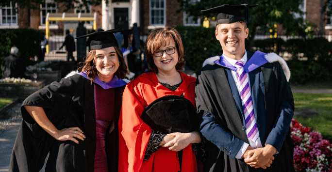 Professor Scott and two graduates