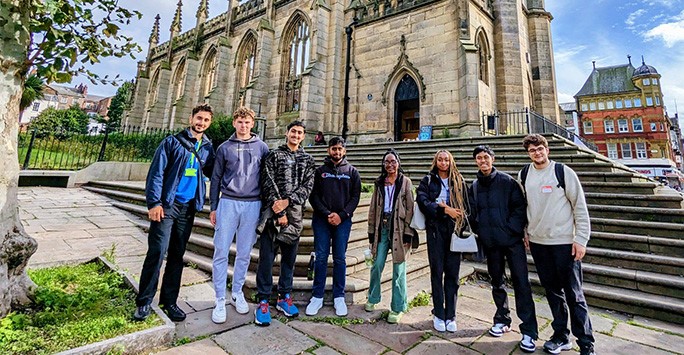 Students by the church during a tour of Liverpool