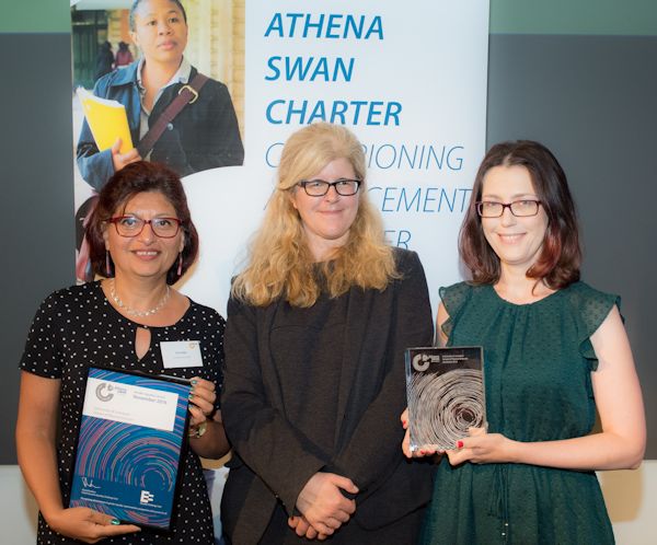 Dr Gita Sedghi (left) and Dr Kamila Zychaluk (right) receiving the Athena SWAN Silver award from Professor Helen Beebee