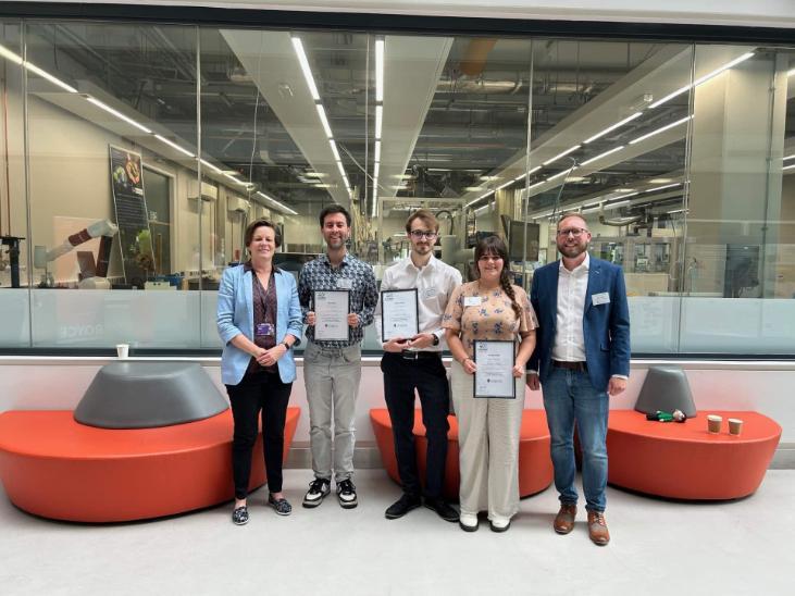Award-winning participants with certificates in the teaching labs.