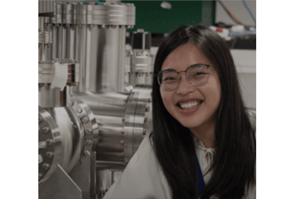Dr Kathy Wu smiling in white lab coat in lab setting