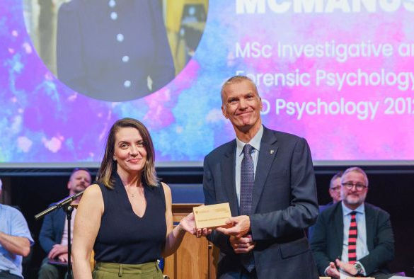 Michelle McManus holds her alumni award