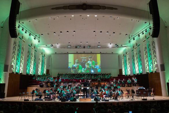 Musicians on stage performing at a In Harmony Liverpool Philharmonic Concert