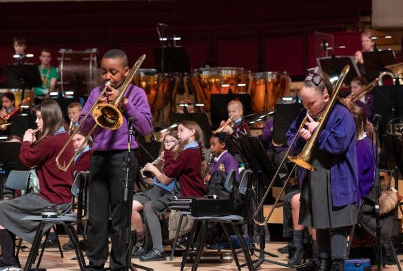 Two students playing trombone