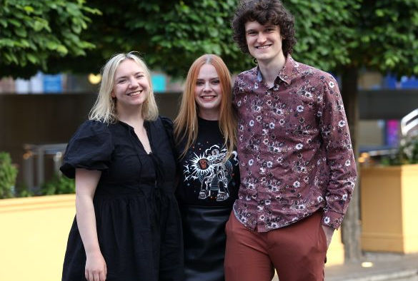 Leanne Jackson stands in the middle of two lecturers