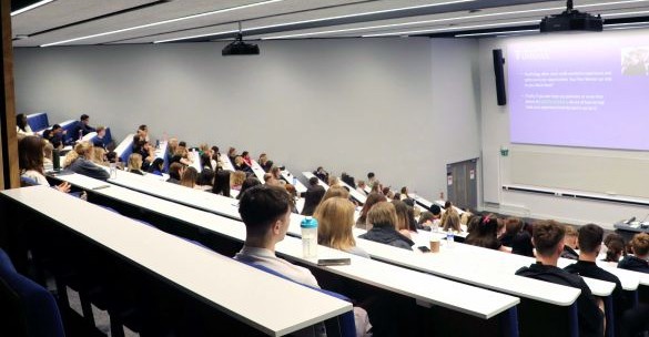 Students sitting in rows in a lecture theatre