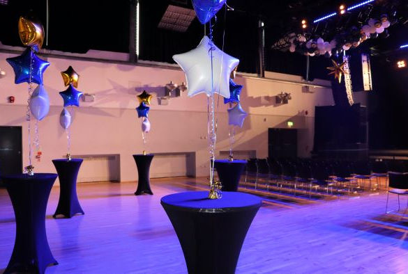 Star shaped balloons and black tables in Mountford Hall