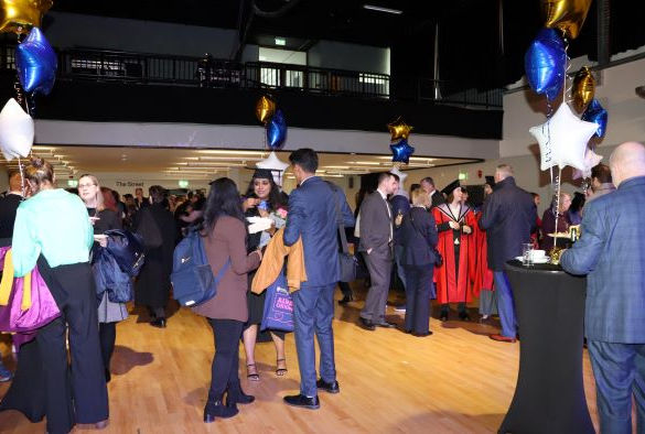 Staff and students standing in Mountford Hall