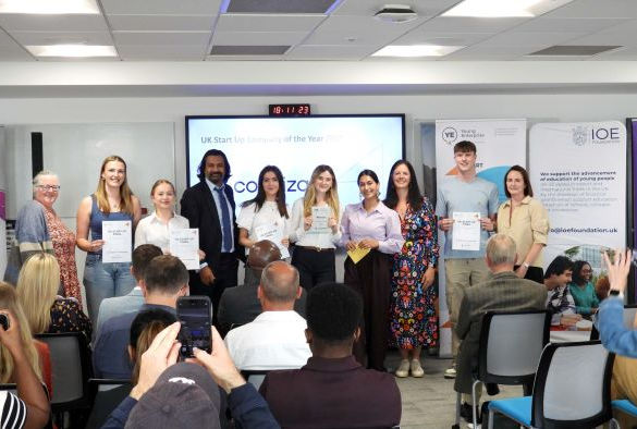 Students and judges stand in front of a projection screen