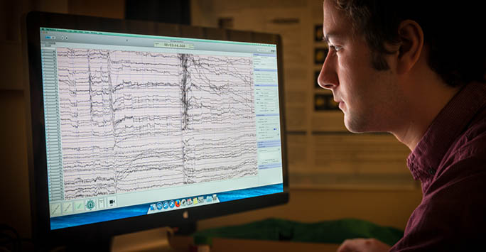 A School of Psychology researcher examines data on a computer screen A School of Psychology researcher examines data on a computer screen