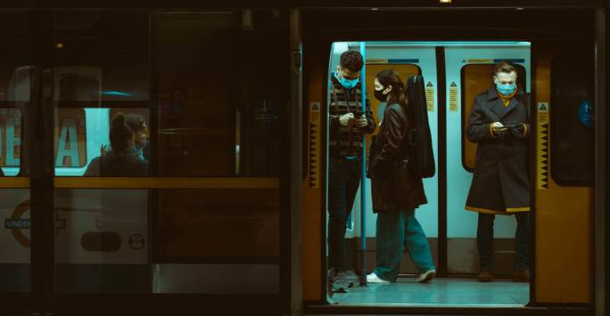 People on train looking at phones