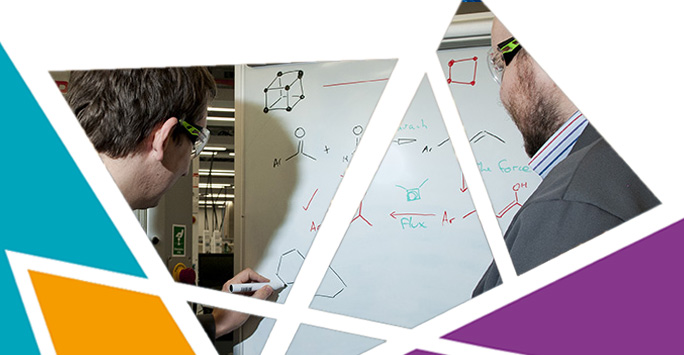 Chemists working on whiteboard Chemists working on whiteboard
