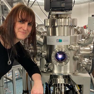 Dr Barker posing near a piece of equipment