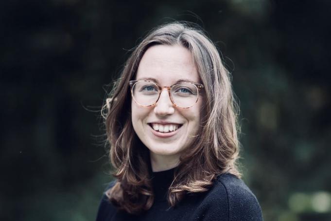 Headshot photo of Dr Nixon smiling against a green background