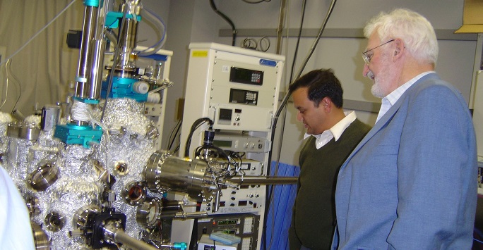Hem Raj Sharma standing near a piece of equipment in a lab