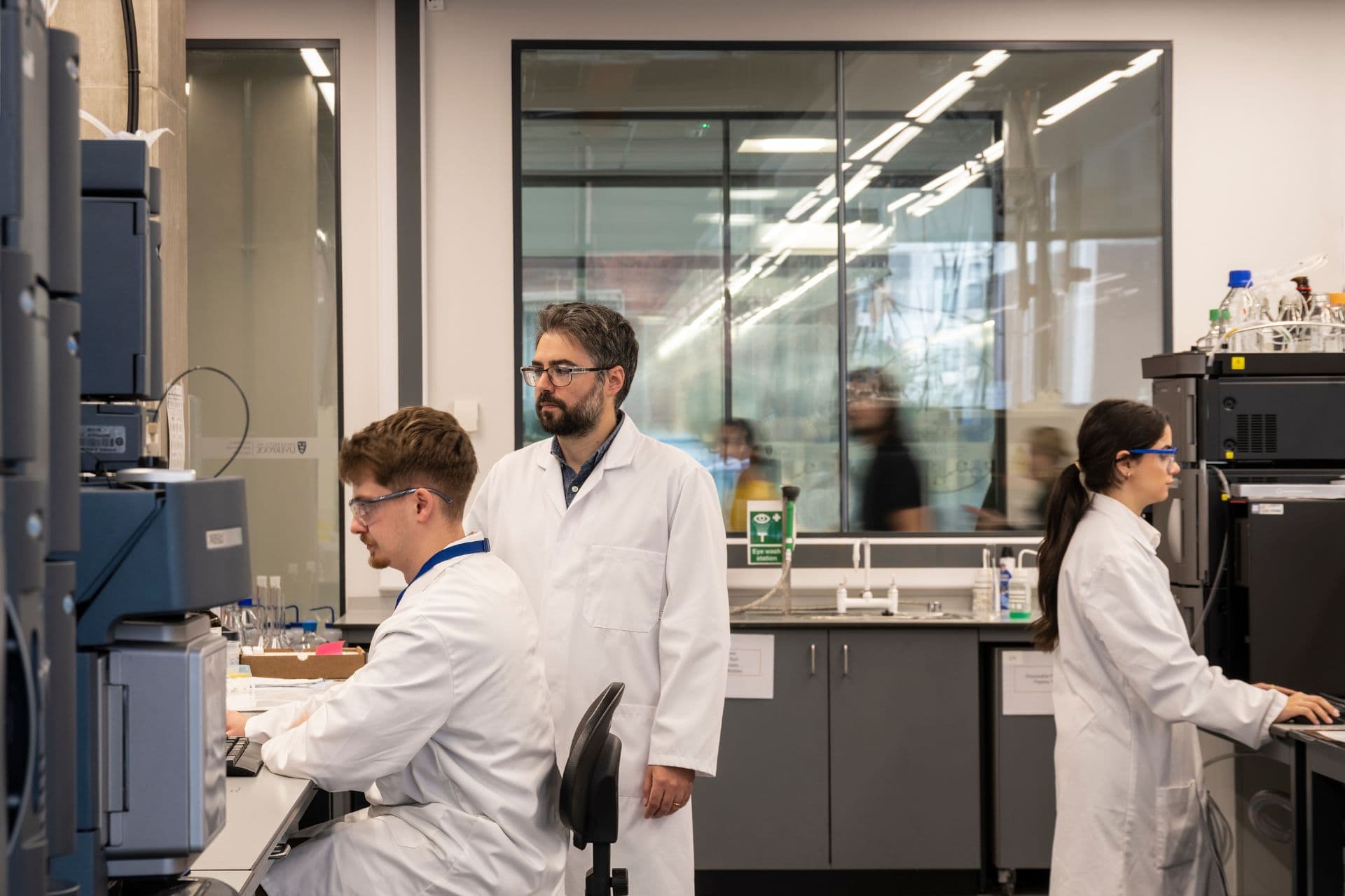 Three scientists working in a chemistry lab