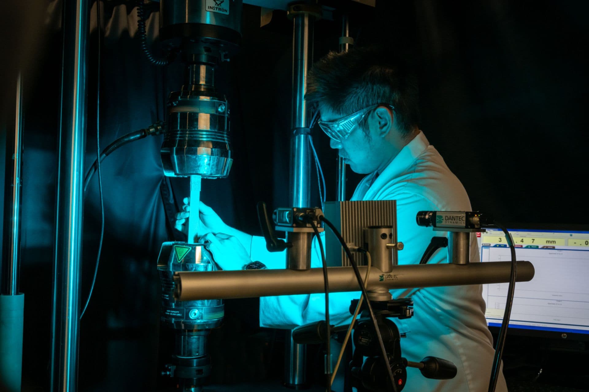 An engineer using a piece of equipment in a lab