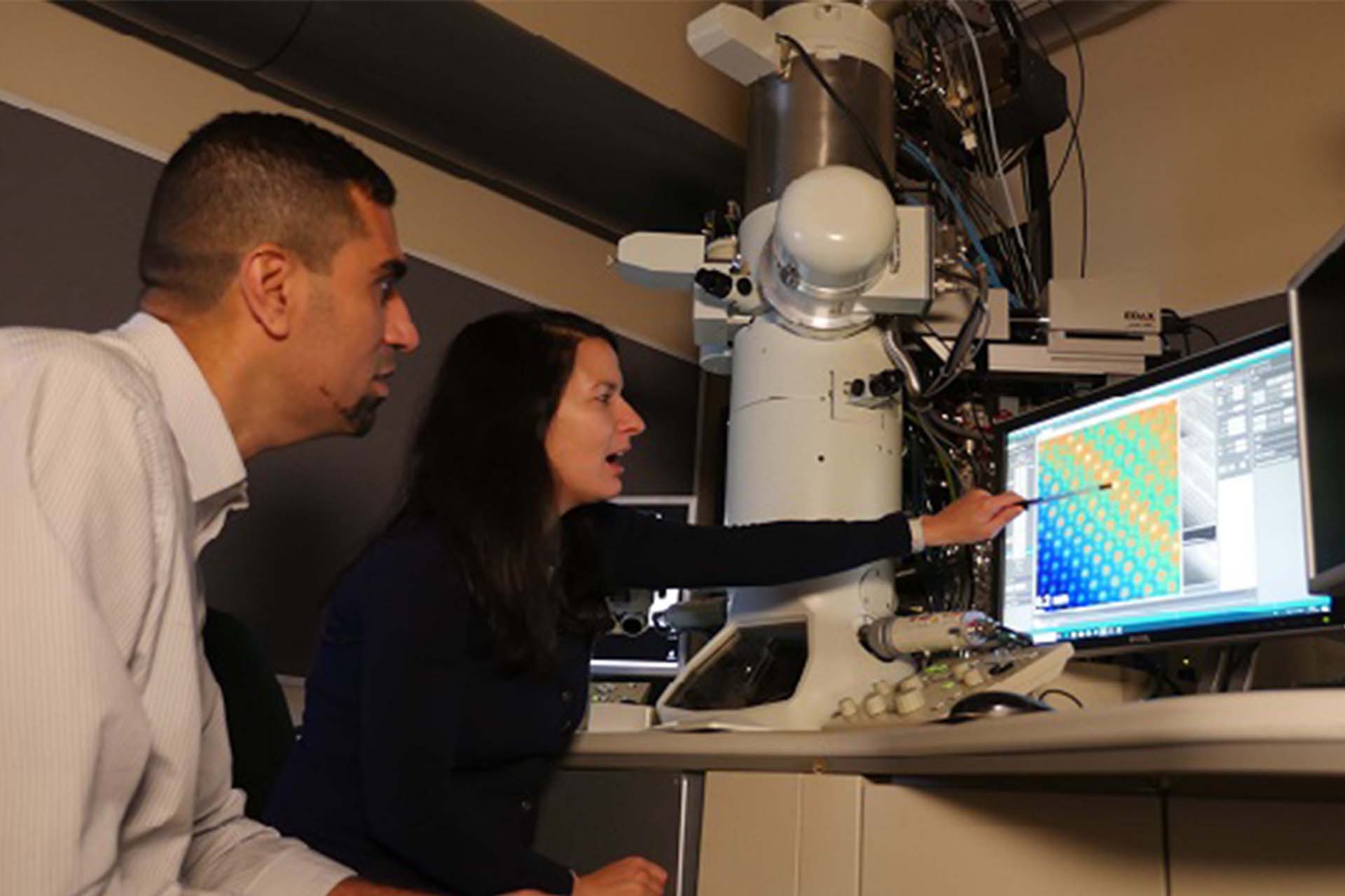 Researchers looking at the screen output of an ultra-high-resolution microscope