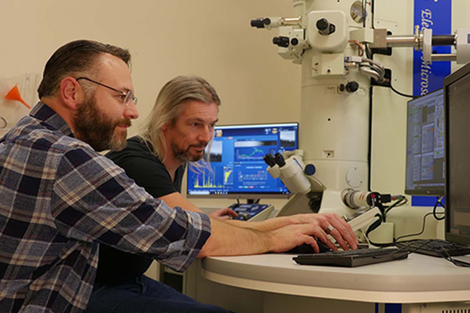 Researchers using a electron microscope