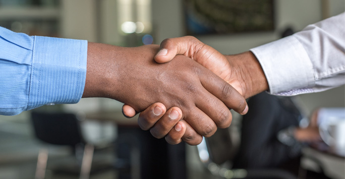 Close up of two hand shaking eachother.