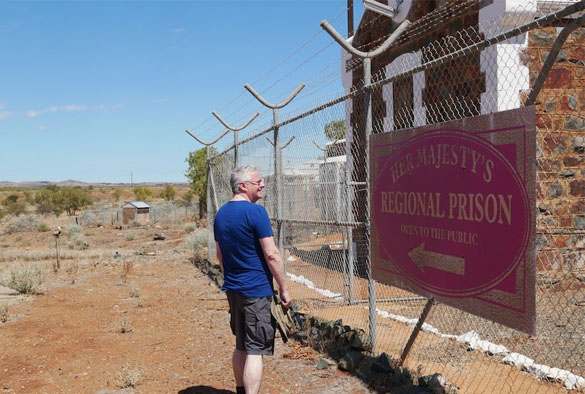Barry Godfrey with Regional Prison sign in Australia