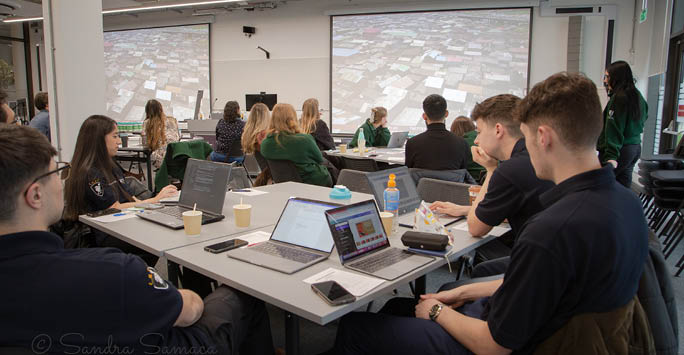 A group of people sat around a table working collaboratively.