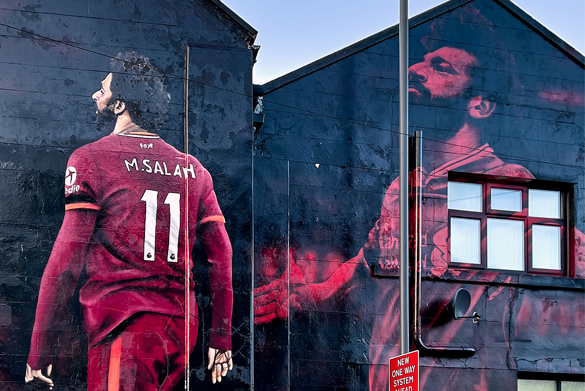 A mural in Liverpool Mohammed Salah in a red Liverpool FC kit.