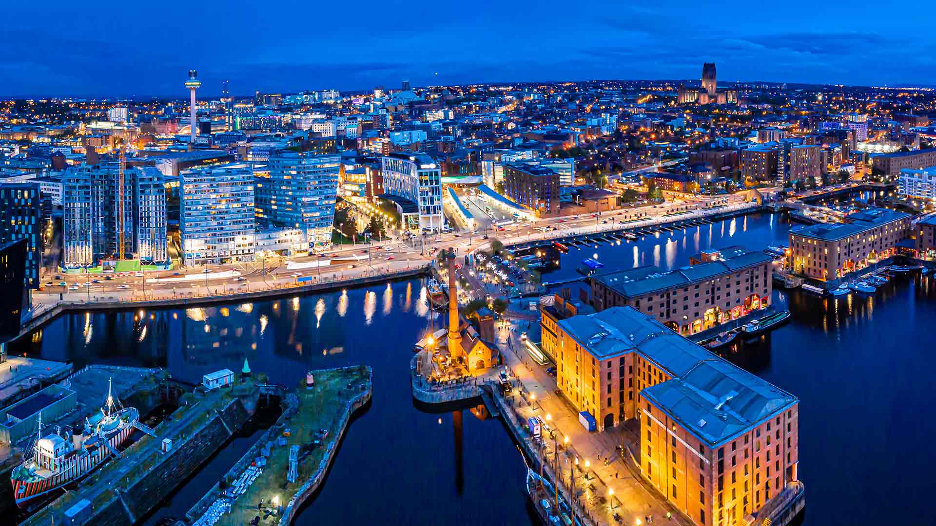 The Albert Dock and Liverpool city skyline at dusk.