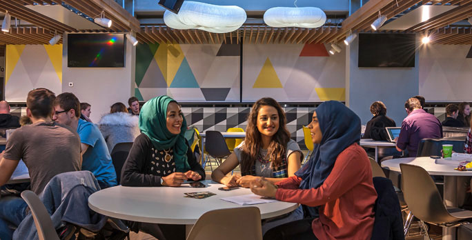 A group of students sitting in the Liverpool Guild of Students.