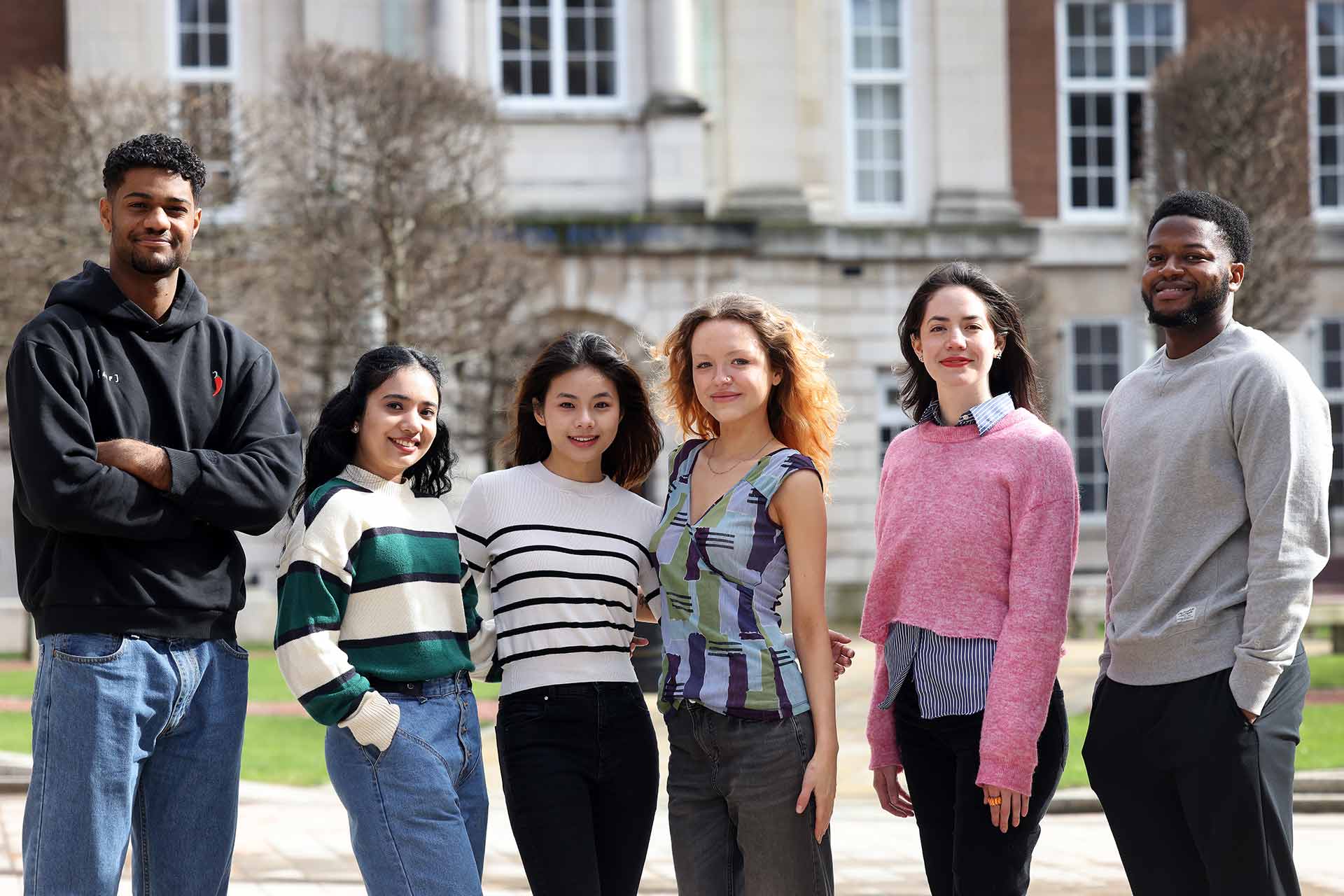 A group of student ambassadors standing in the Quad on campus.