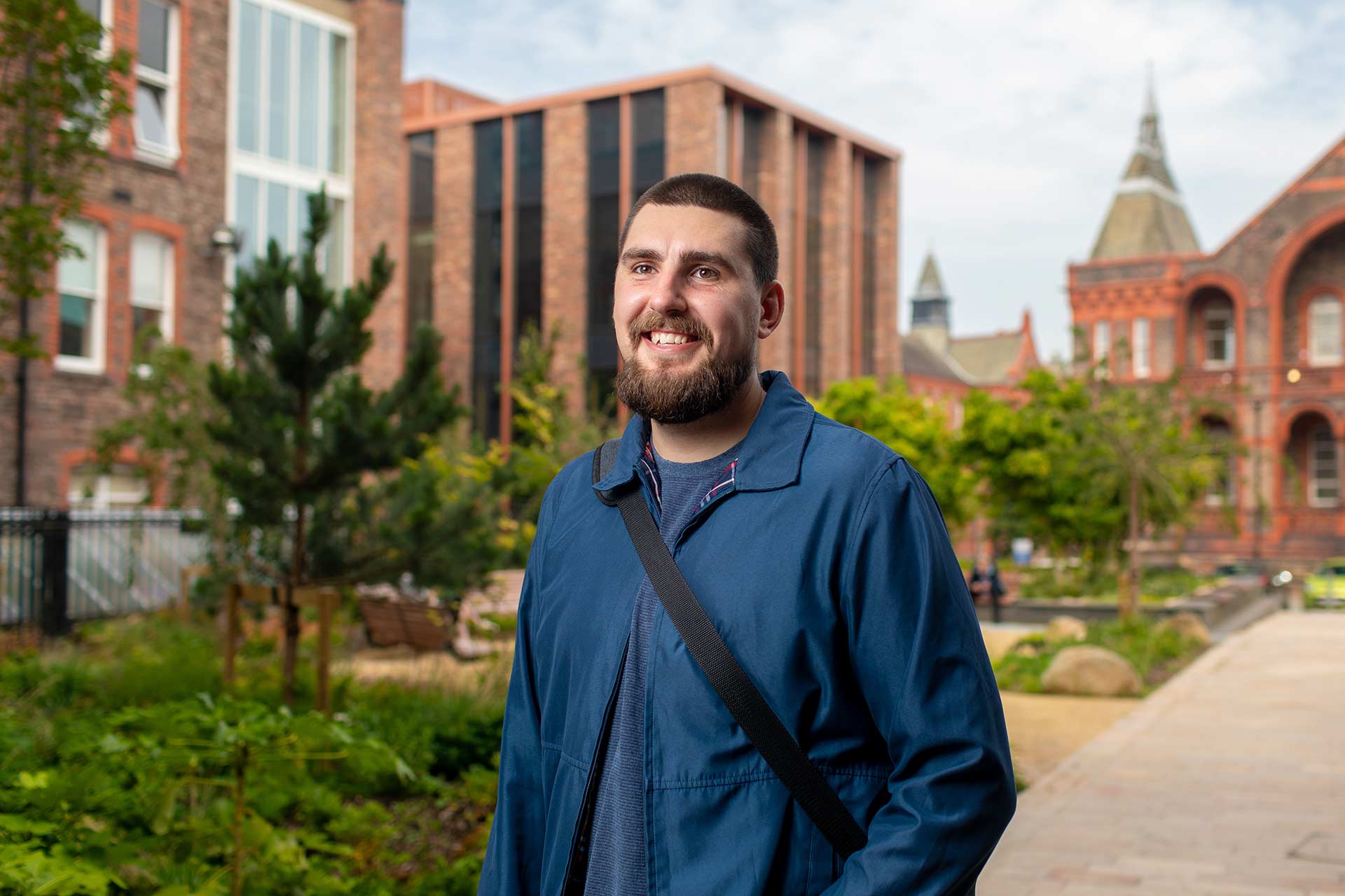 A student walks through some gardens on campus.