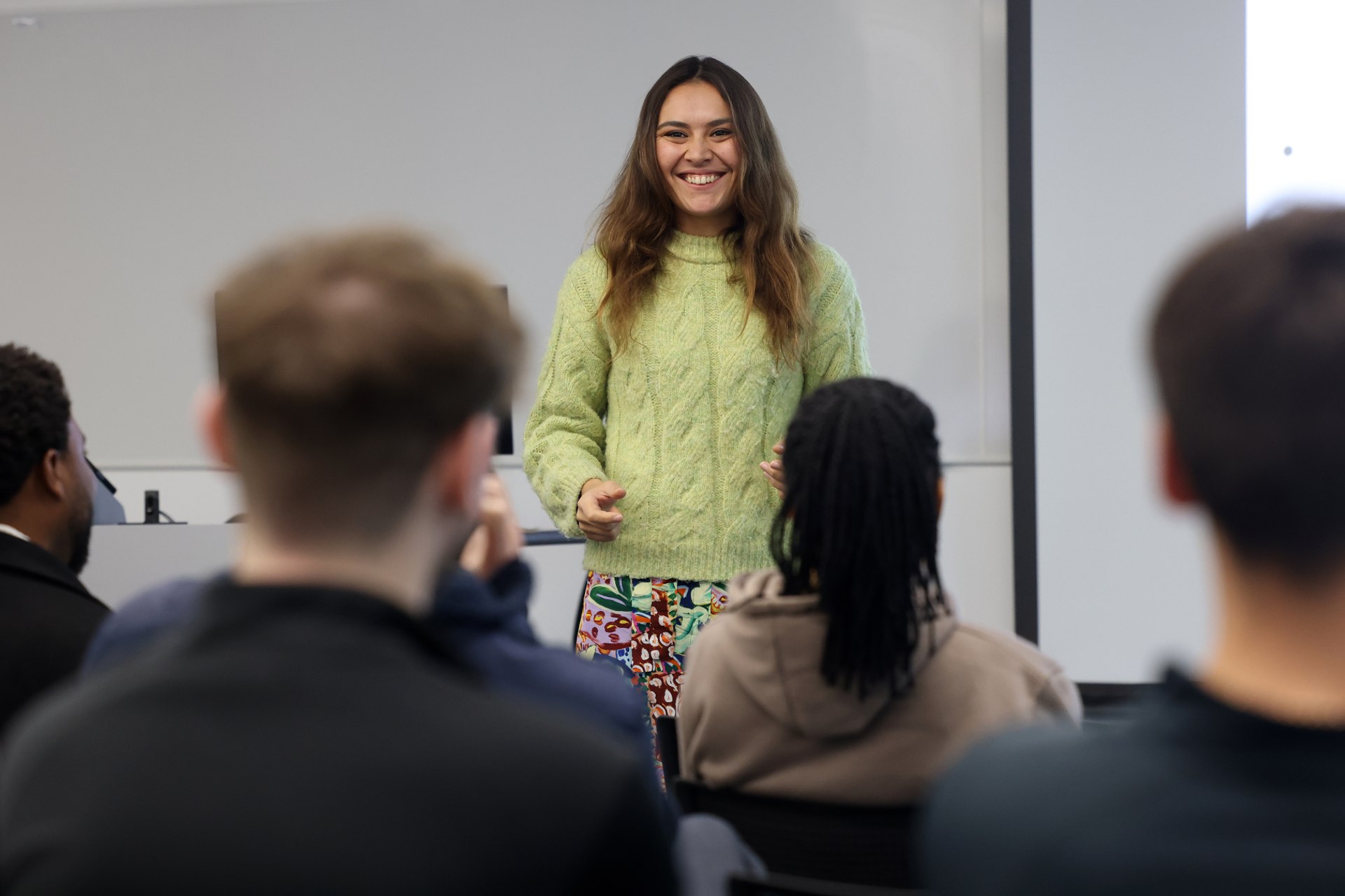 A student is speaking in front of a group in a seminar.