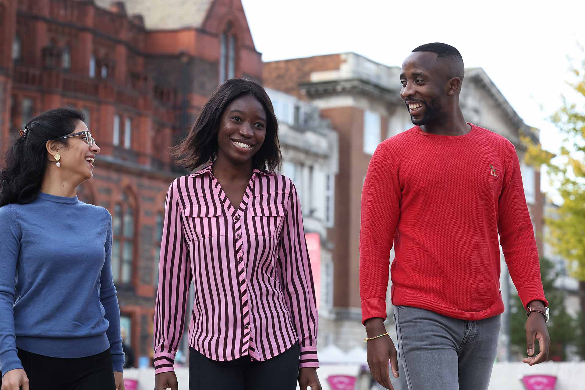 Three students walking in University Square.