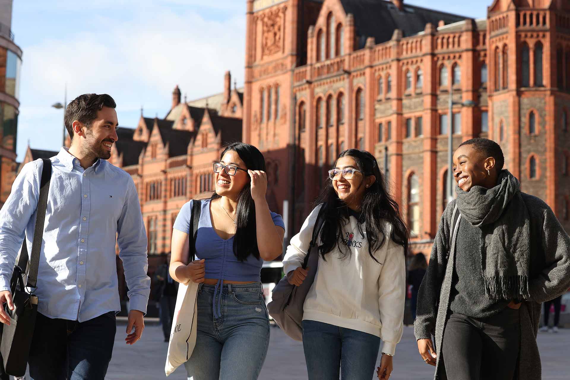 Four students chatting in University Square.