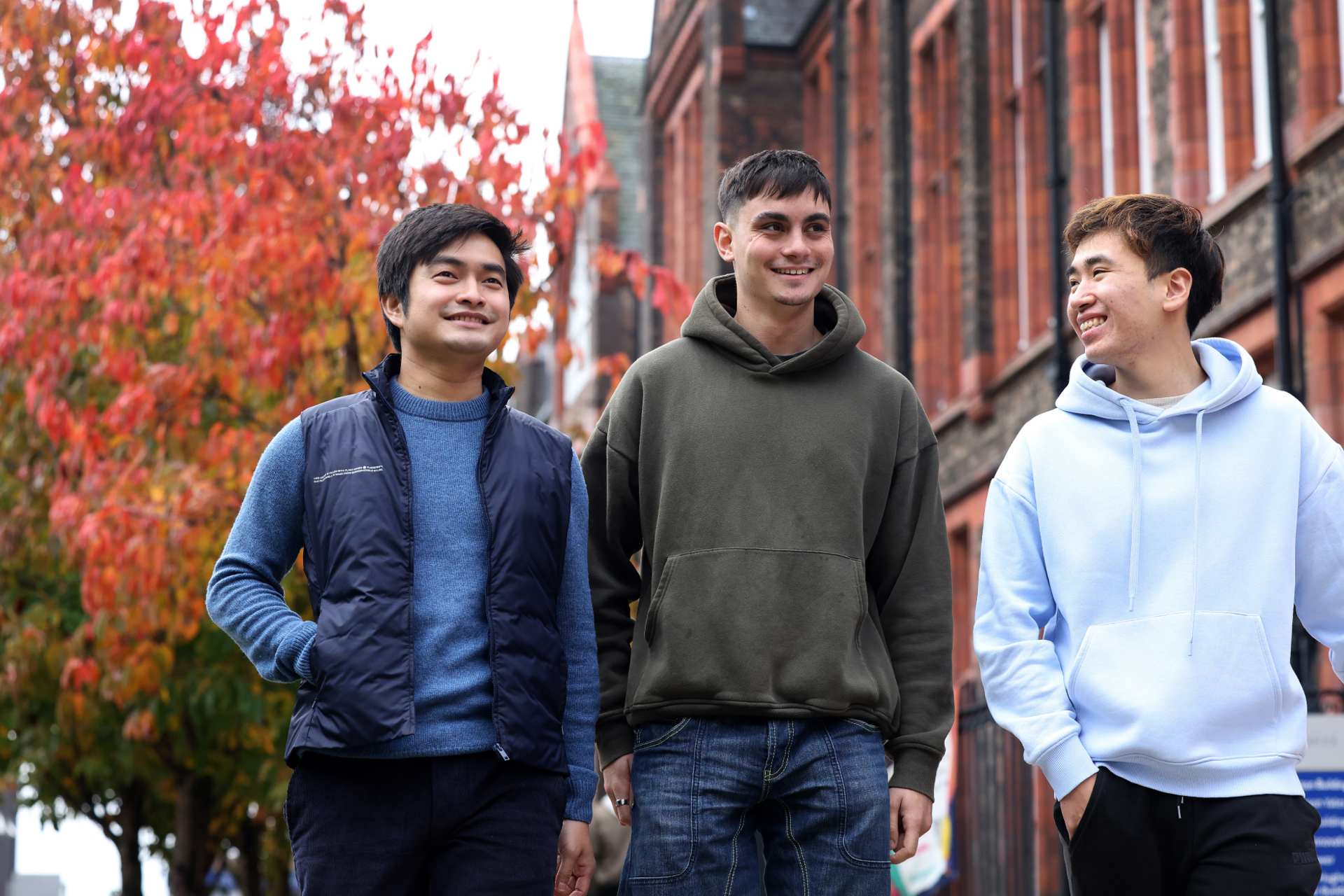 A group of students walking and talking on campus.