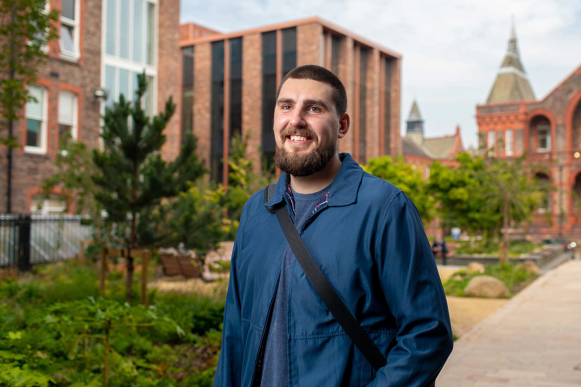 A PhD student walking on campus.