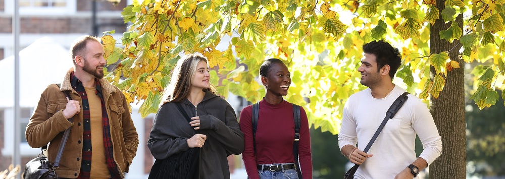 Postgraduate students walking through campus