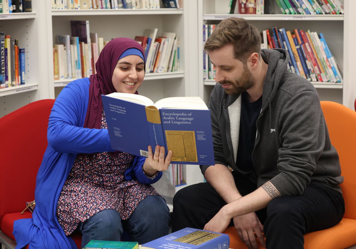 A teacher and student studying the language of Arabic