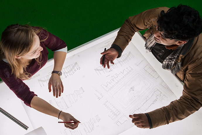 Students working on a joint project together around a table 