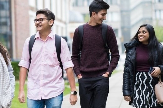 Three students walking together outdoors