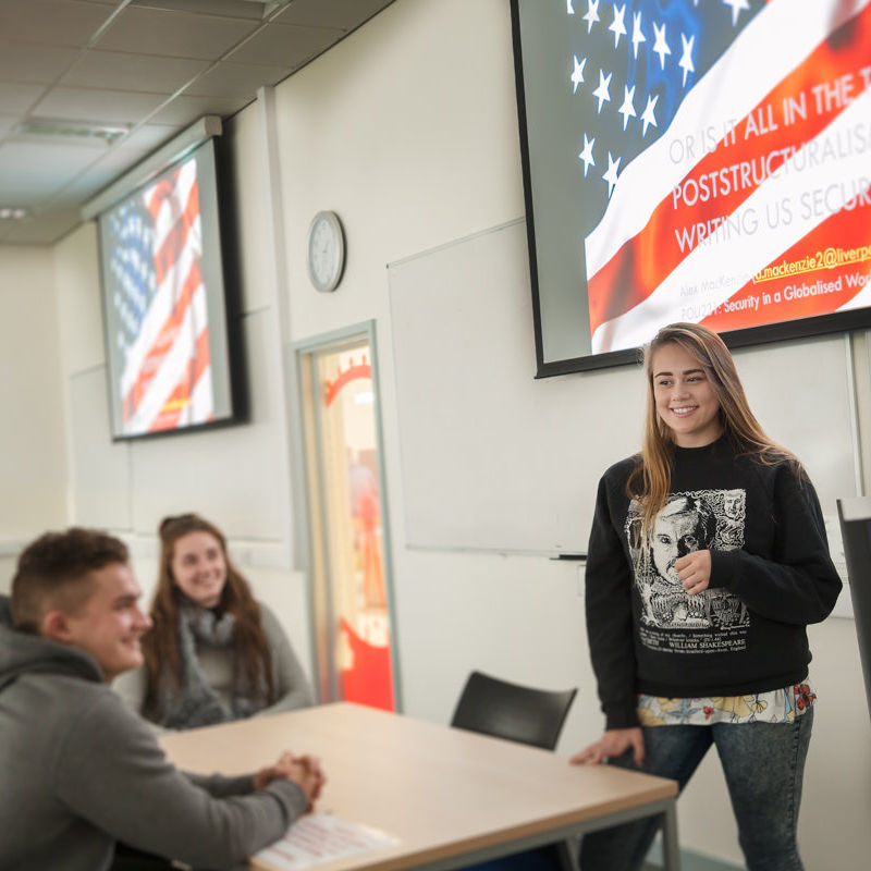 Politics students in room in front of presentation screen