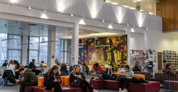 A wide shot of students studying in the Sydney Jones Library