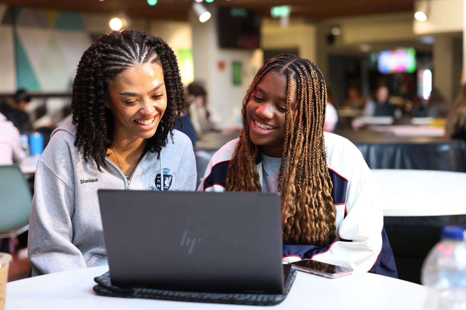 Two students looking at a laptop together in the Guild.