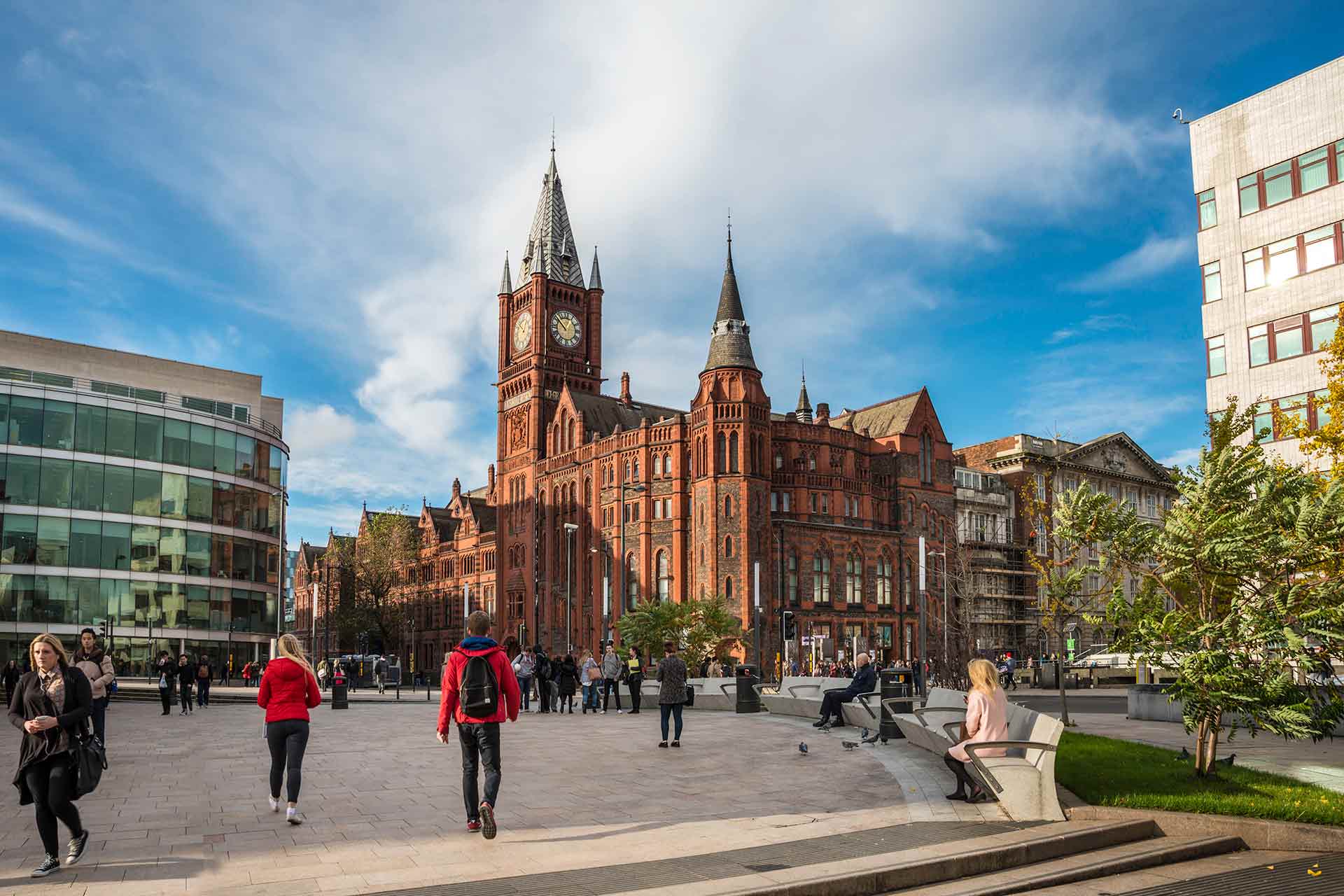 People walking through University Square, with the Victoria Gallery & Museum building visible behind them.
