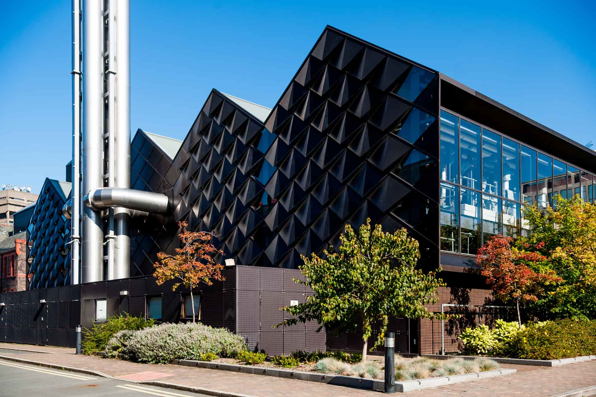 The energy centre on the university of Liverpool campus. The building has glass windows on one side, and scaly metal tiles on the other, reminiscent of an armadillo.