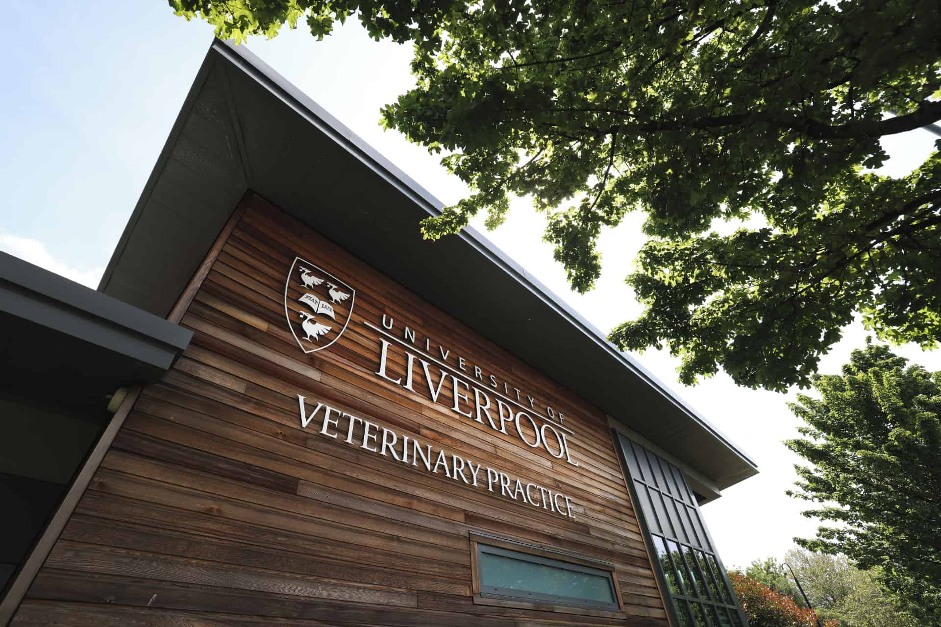 A wooden building with the University of Liverpool written across the top, and the logo for the university of liverpool.