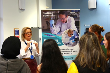 Photo of a group of students listening to a female representative discuss careers