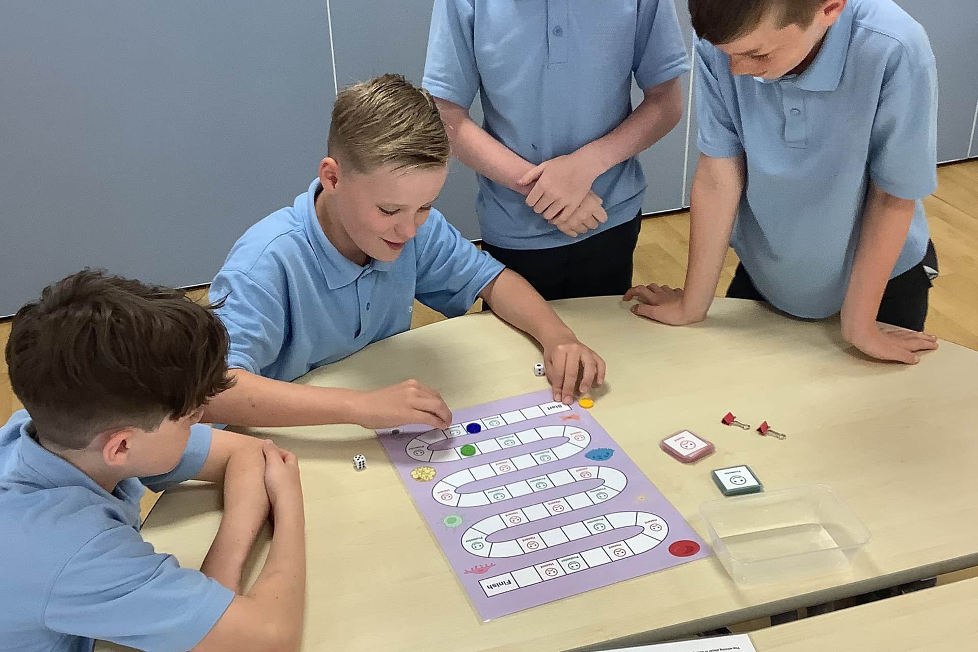 School aged children playing board game