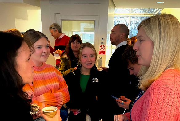 Pupils and staff chatting in between lectures