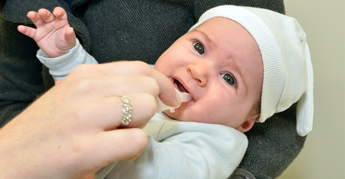 Baby receiving the oral rotavirus vaccine
